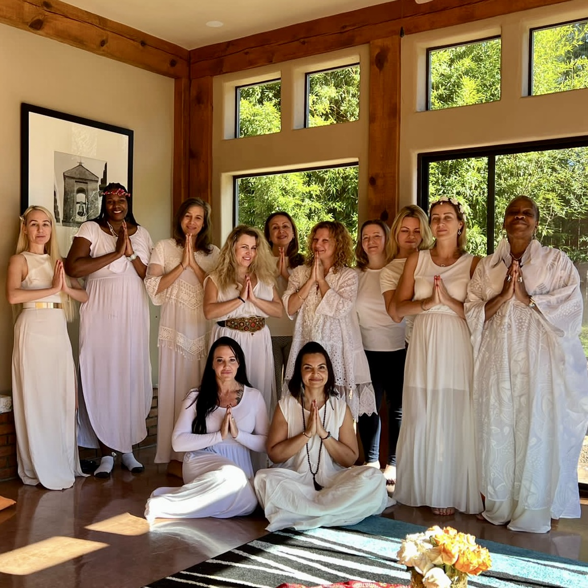 A group of women in white gathered in circle