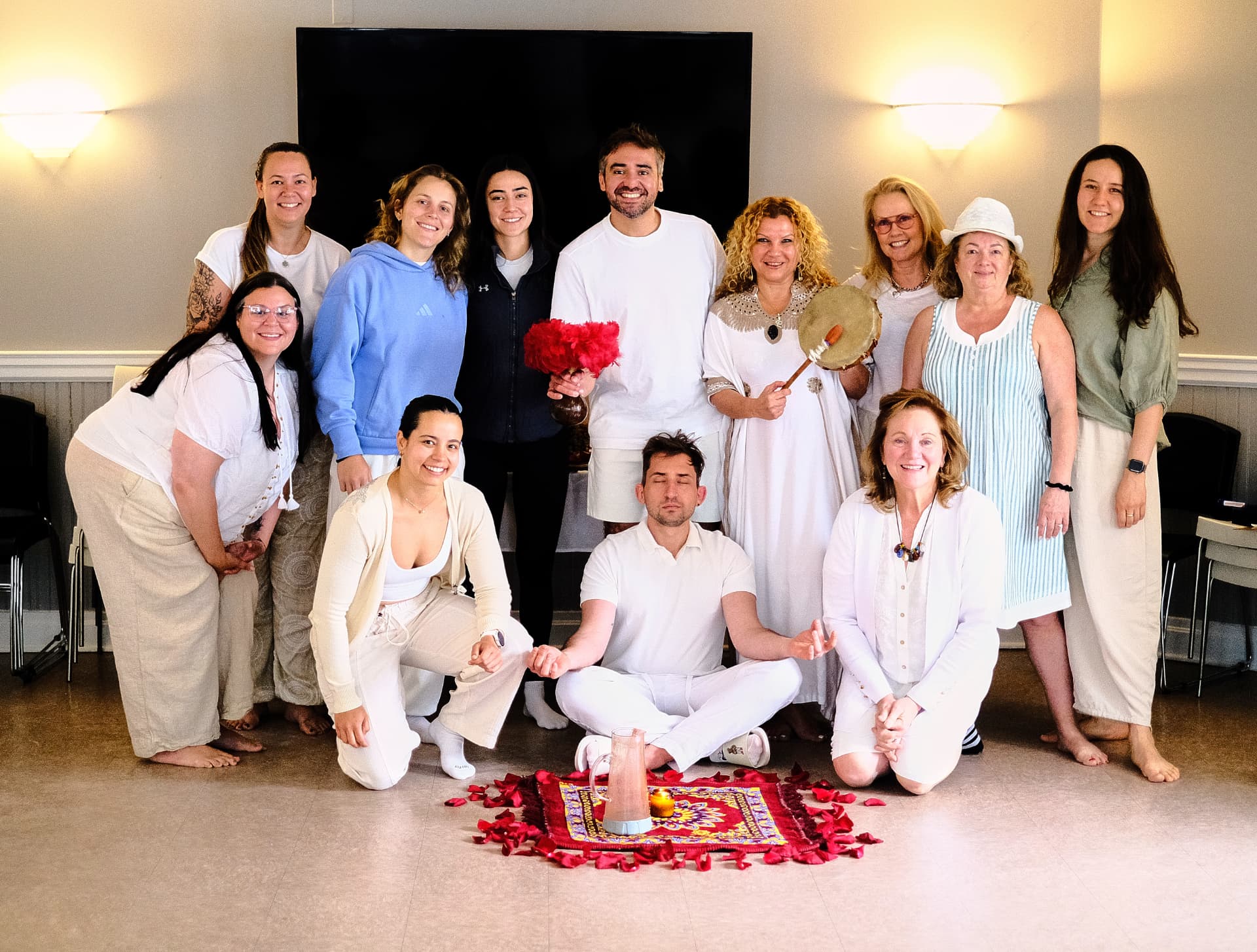 Ceremonial gathering with rose petals, drum and candle